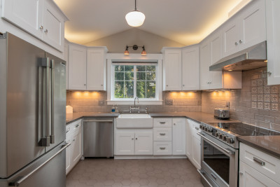 white kitchen with stainless steel modern refrigerator, modern cooking surface, conventional oven, and dish washer